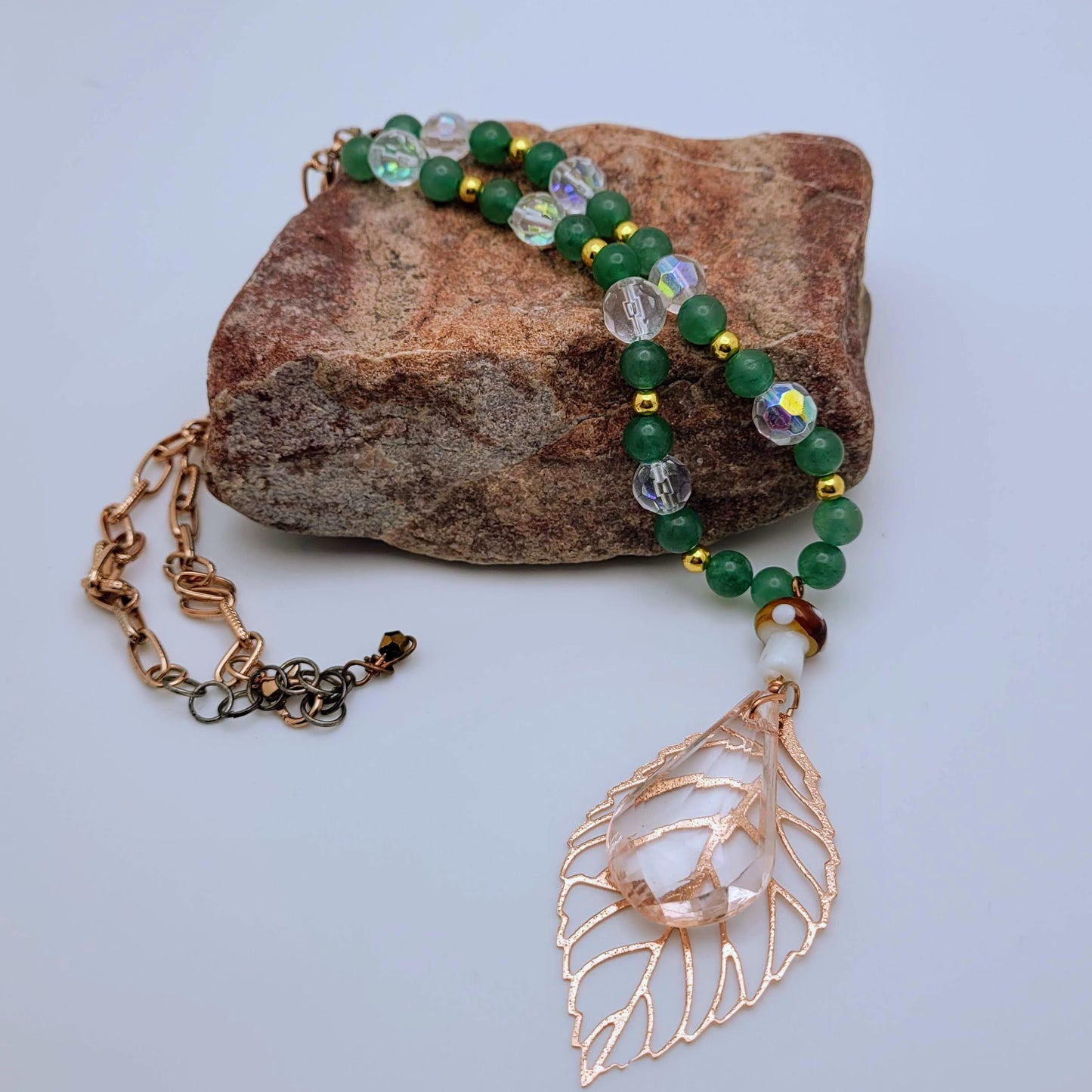 Elegant statement necklace with stunning Aventurine beads said to bring good luck and prosperity. Rose gold leaf pendant and vintage lucite drop add a touch of sophistication.