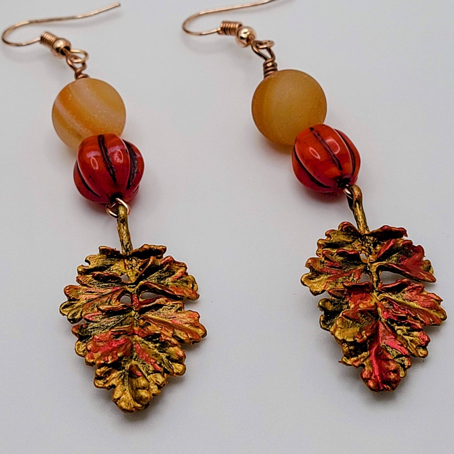 Brass leaves hand painted to represent the vibrant fall colors. Paired with carnelian and glass beads for your go-to pair this fall!